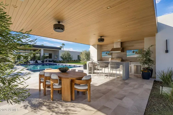 a view of a patio with dining table and chairs