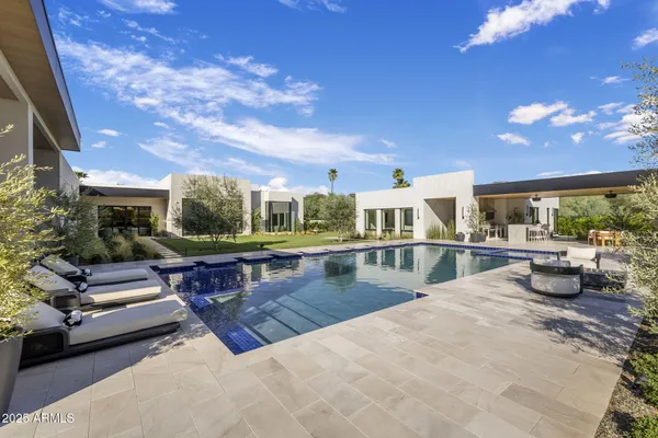a view of a patio with swimming pool table and chairs