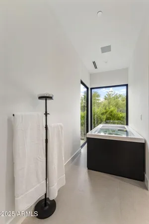 a room with a large window and white walls