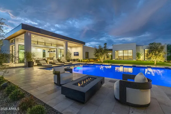 a living room with furniture a swimming pool and outdoor seating