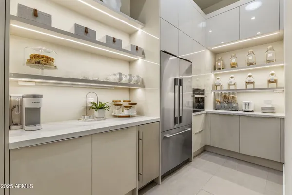 a kitchen with stainless steel appliances a refrigerator and cabinets