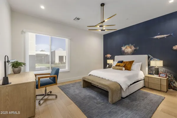 a bedroom with a bed and a chandelier