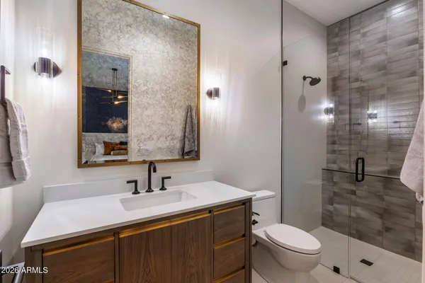 a bathroom with a sink a toilet and shower