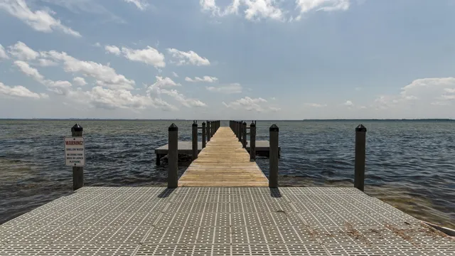 a view of a patio with table and chairs under an umbrella