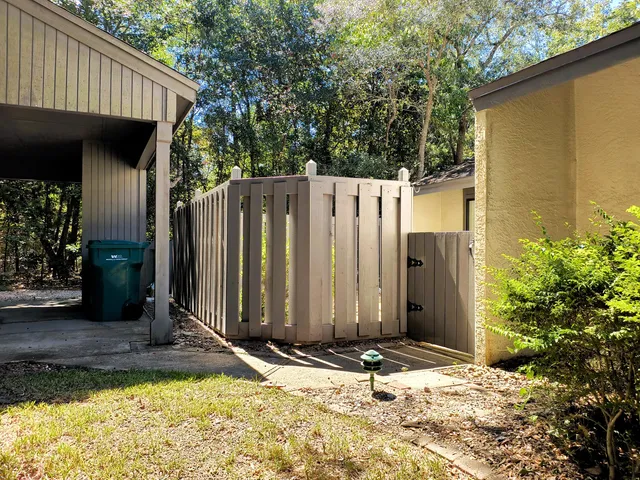 a view of backyard with a barn in the background