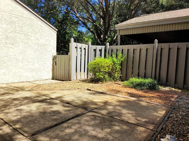 a view of a brick house with wooden fence