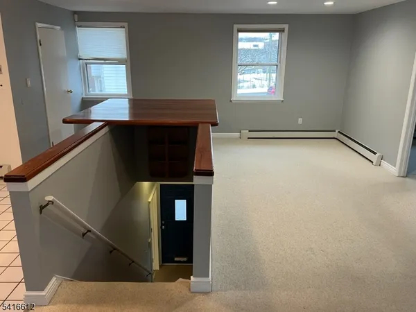 a kitchen with kitchen island a stove and a refrigerator