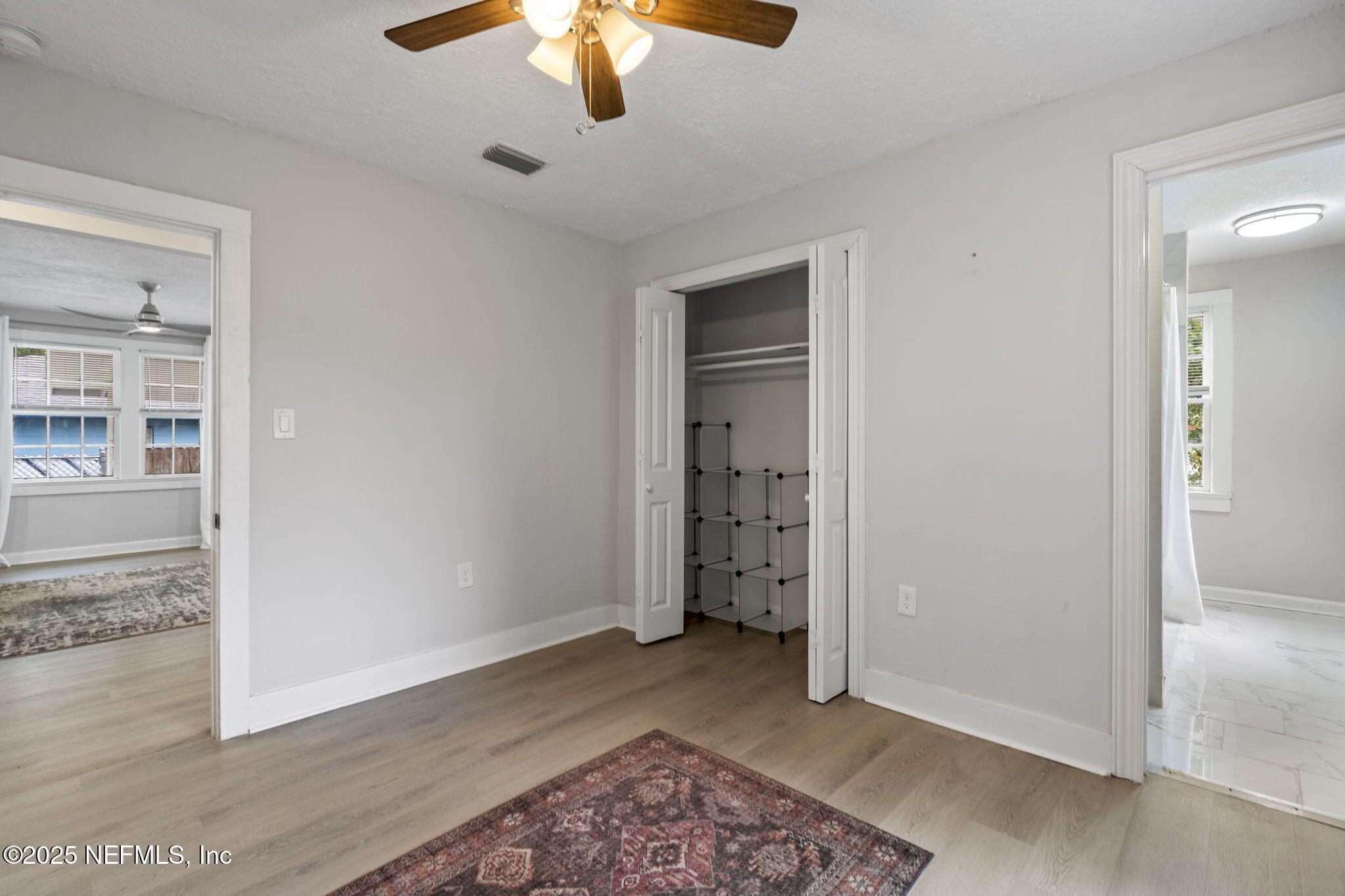 3910 Grant Road Jacksonville, FL 32207 - Photo 11 of 36 an empty room with closet and a chandelier fan