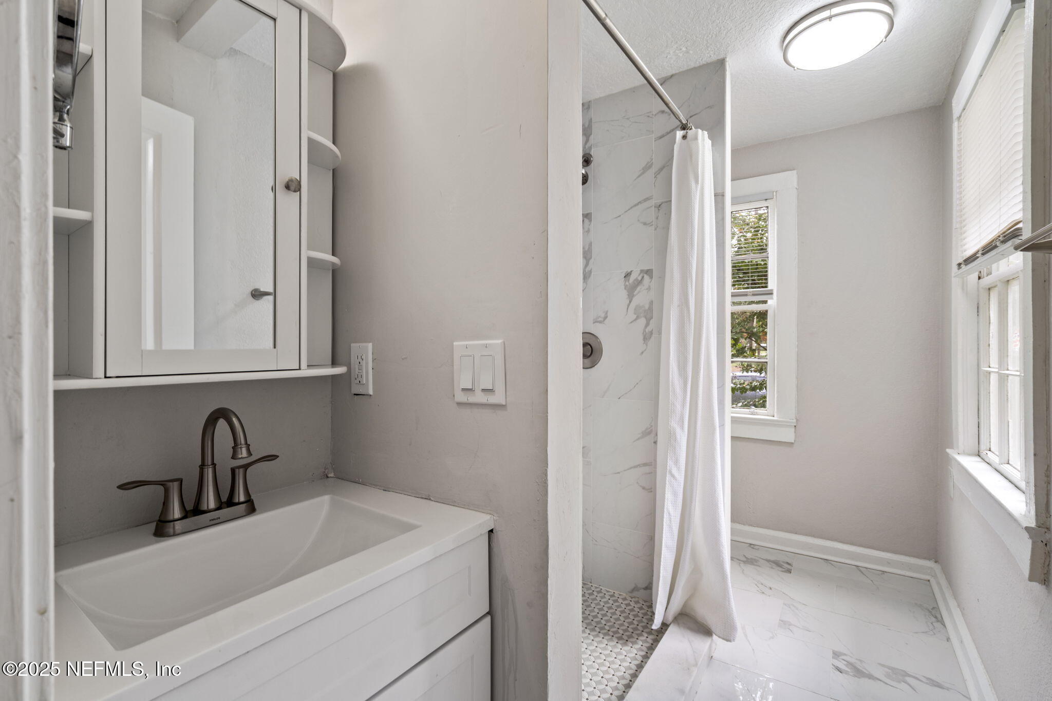 3910 Grant Road Jacksonville, FL 32207 - Photo 13 of 36 a bathroom with a sink and a shower