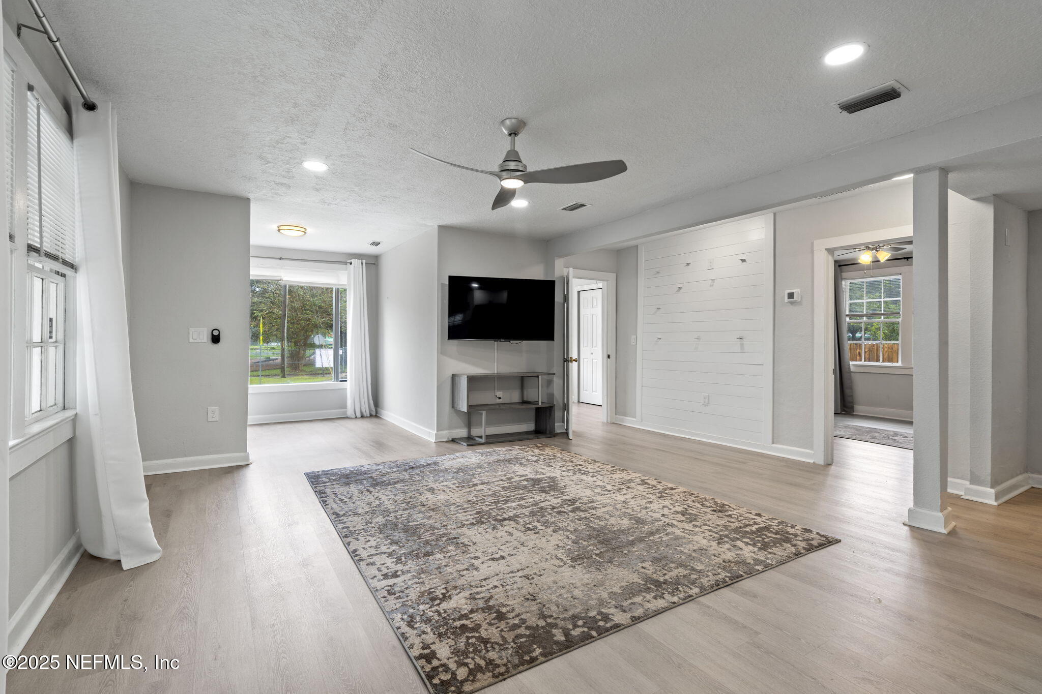 3910 Grant Road Jacksonville, FL 32207 - Photo 14 of 36 wooden floor in an empty room with a fireplace