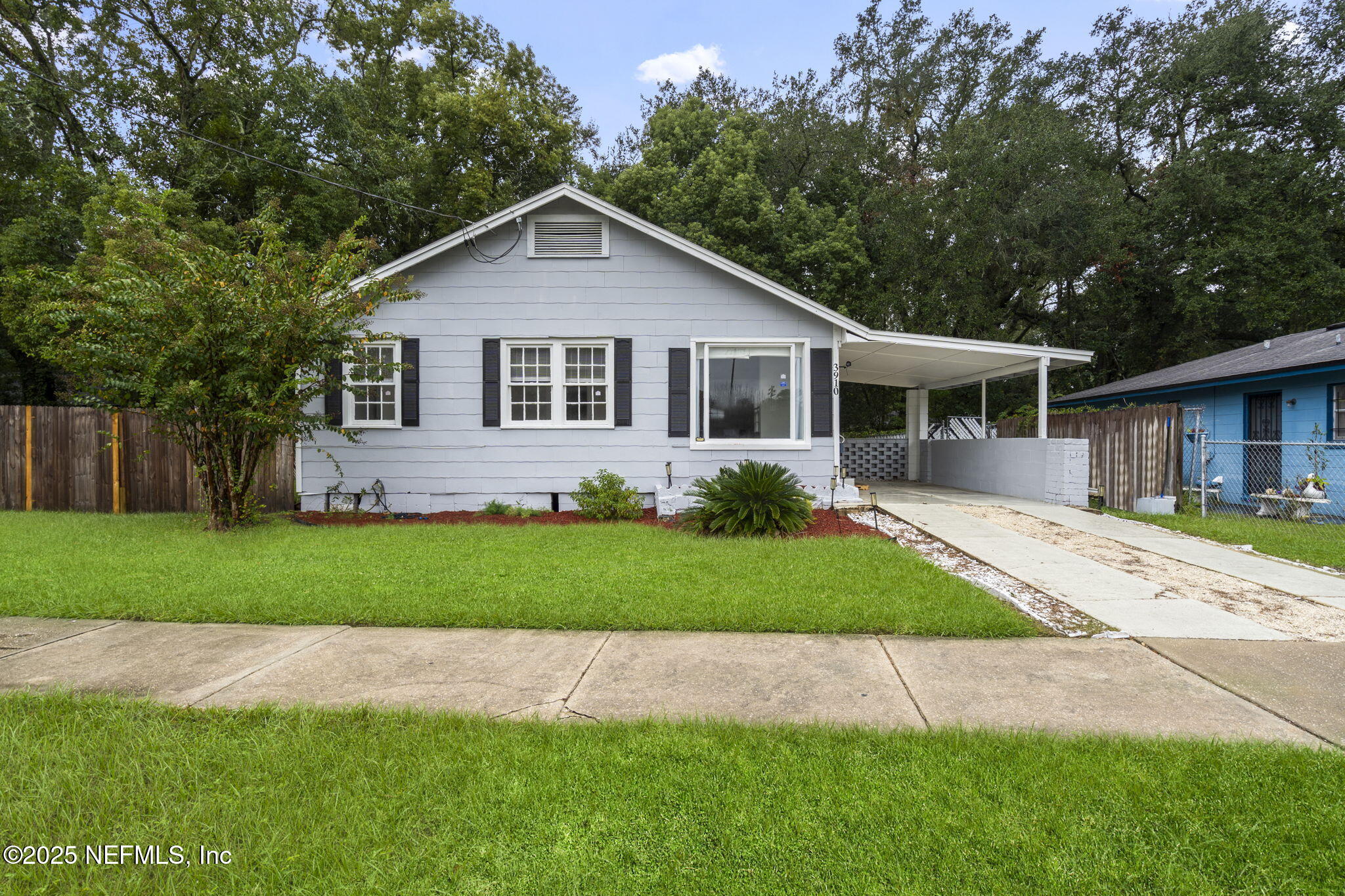3910 Grant Road Jacksonville, FL 32207 - Photo 2 of 36 a front view of a house with a garden and yard