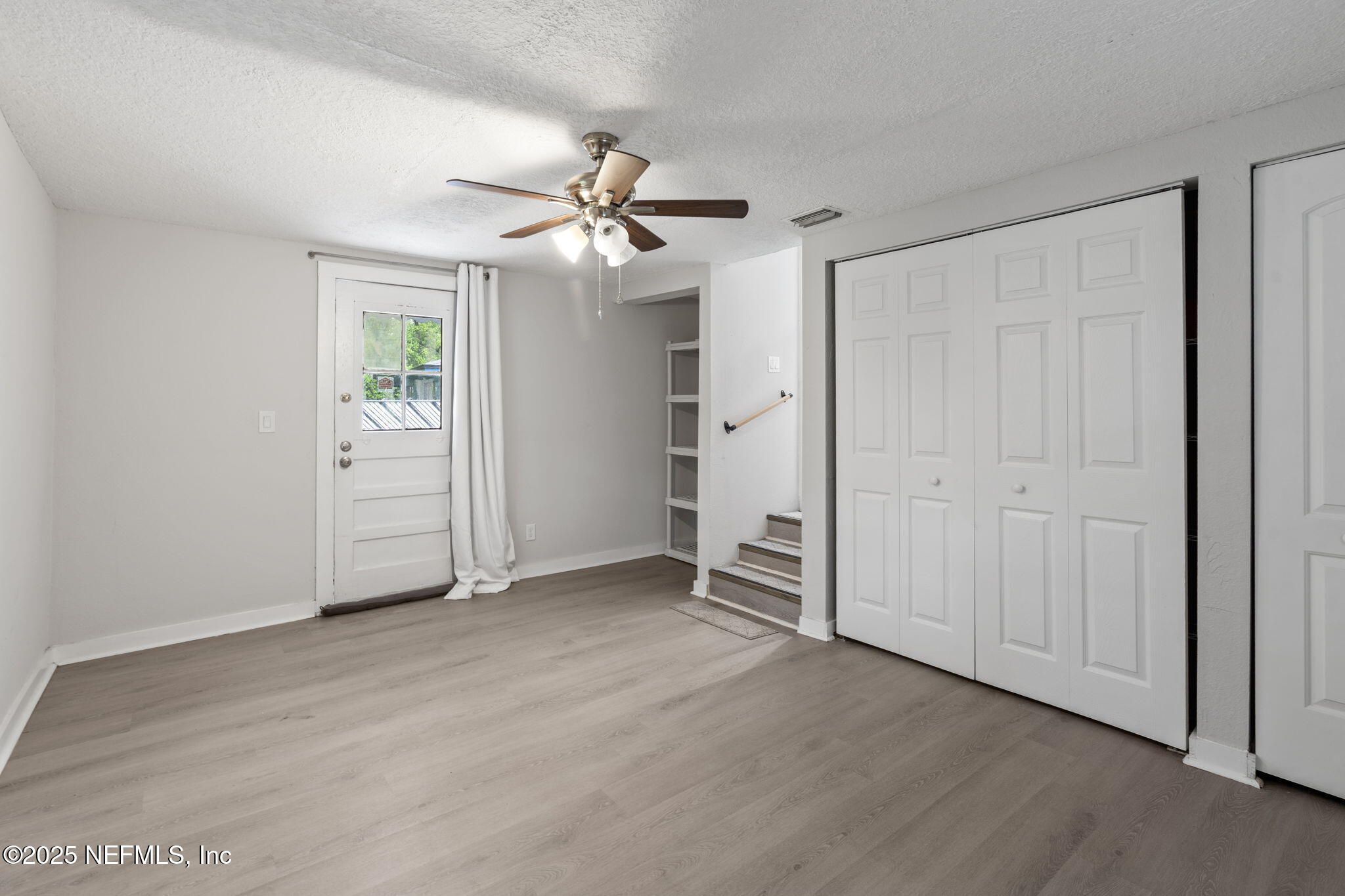 3910 Grant Road Jacksonville, FL 32207 - Photo 24 of 36 an empty room with closet and a ceiling fan