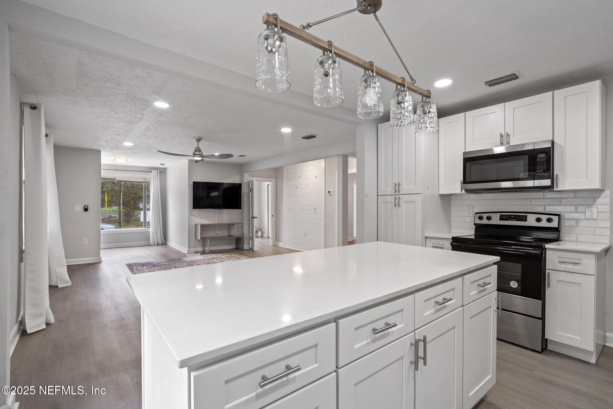 3910 Grant Road Jacksonville, FL 32207 - Photo 6 of 36 a large kitchen with kitchen island a sink stainless steel appliances and cabinets
