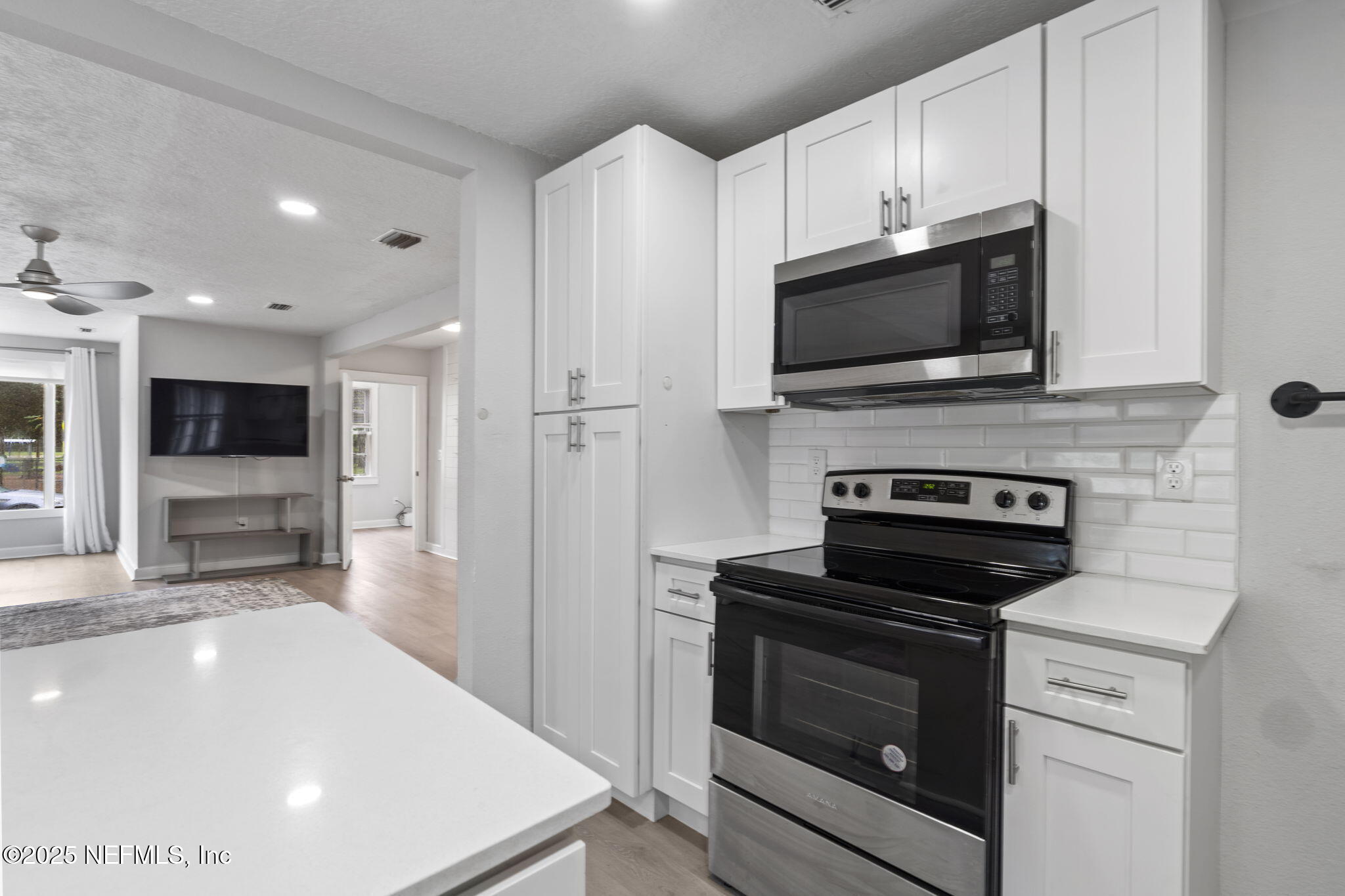 3910 Grant Road Jacksonville, FL 32207 - Photo 7 of 36 a kitchen with a stove and a microwave
