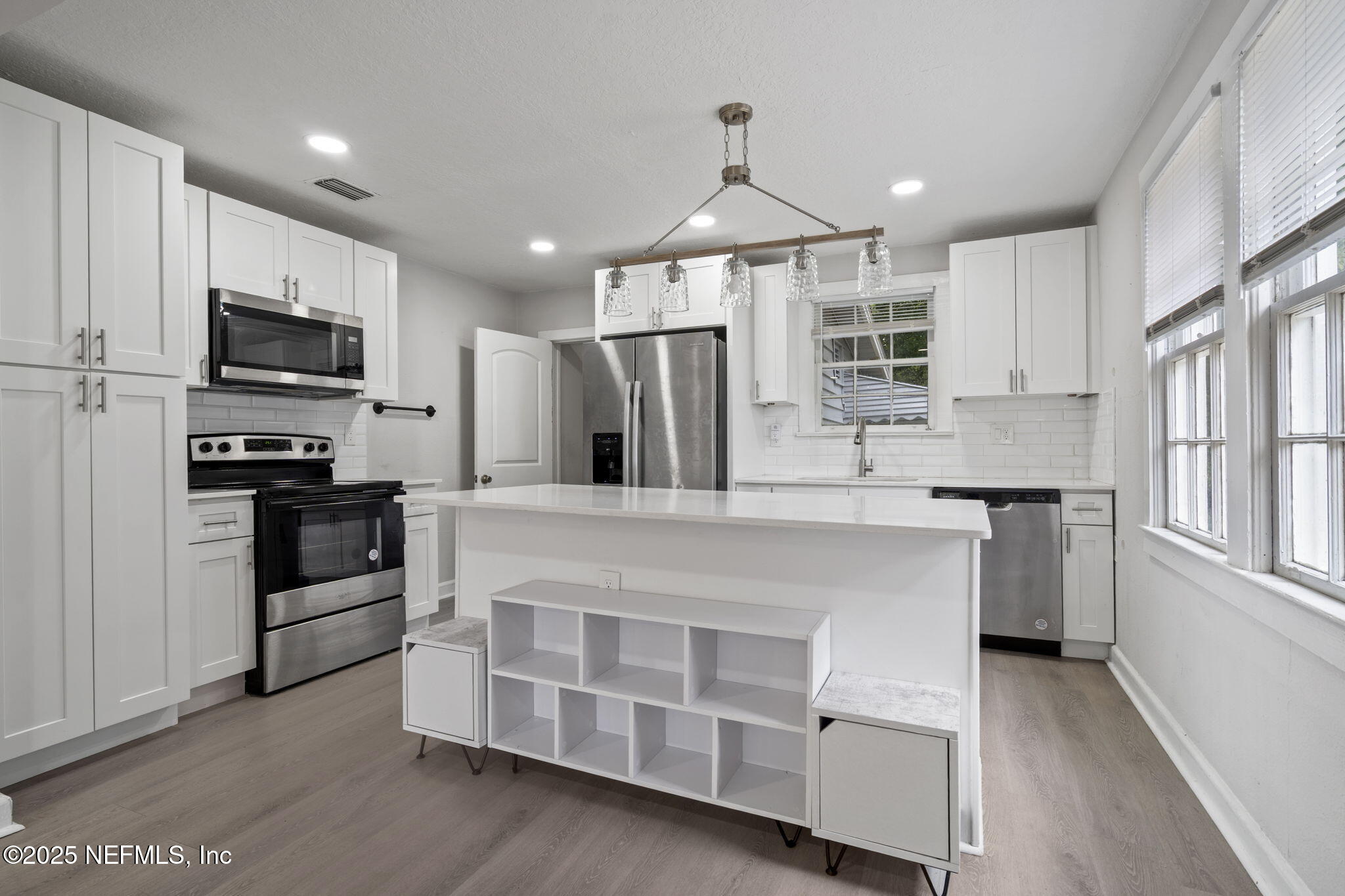 3910 Grant Road Jacksonville, FL 32207 - Photo 8 of 36 a kitchen with stainless steel appliances kitchen island granite countertop a stove and a refrigerator