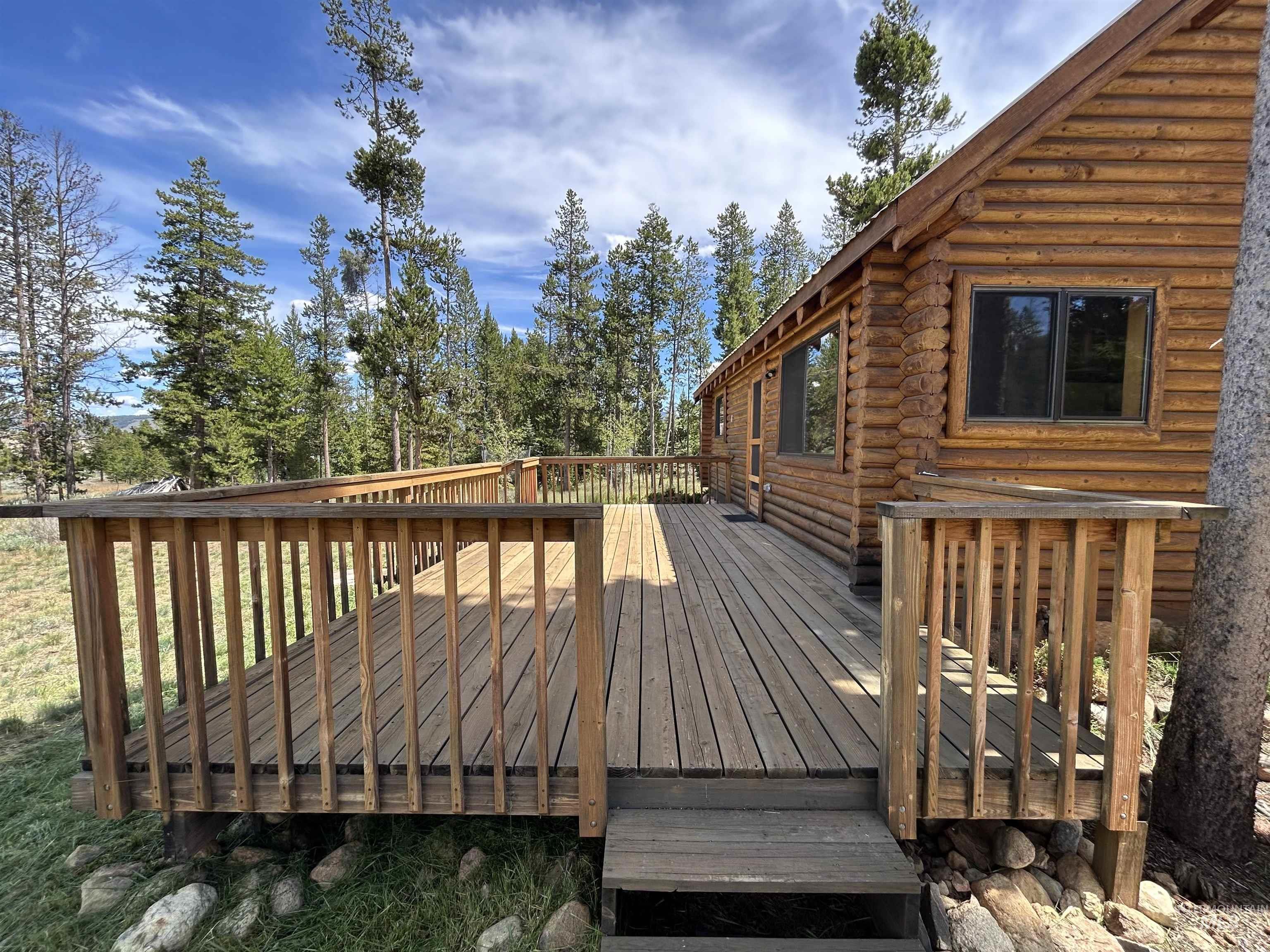 35 Sawtooth Way Stanley, ID 83278 - Photo 2 of 36 Expansive wood-finish deck with integrated railing system