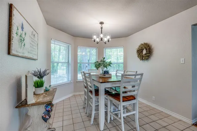 a view of a dining room with furniture and chandelier