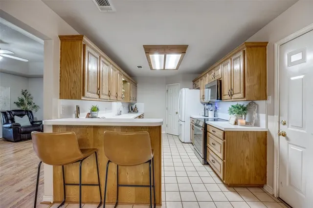 a kitchen with kitchen island cabinets and chairs
