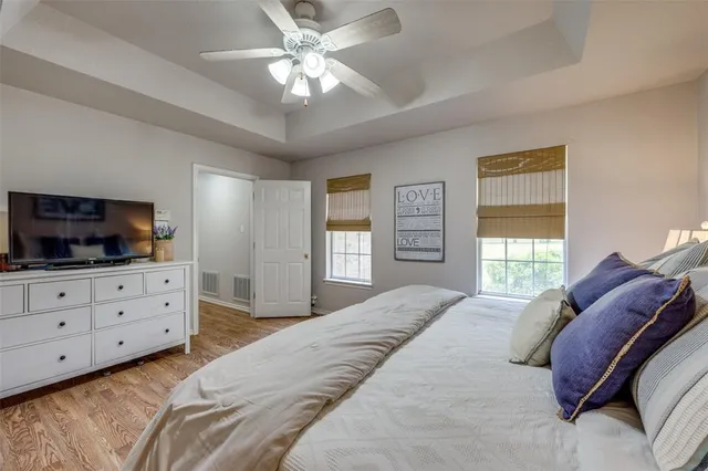 a bedroom with a bed a window and a dresser