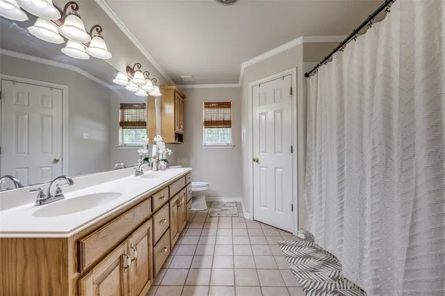 a spacious bathroom with a double vanity sink a and a mirror
