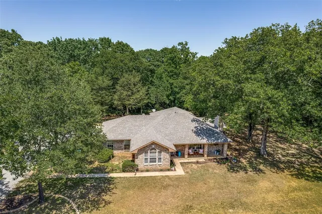a view of a house with roof and a tree