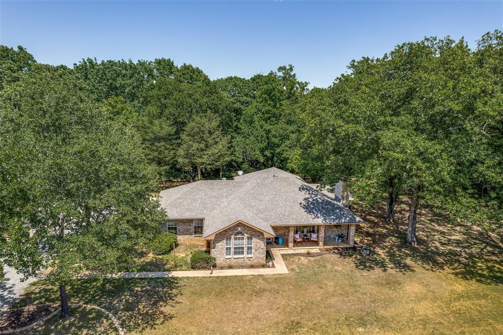 4942 Highway 69 Denison, TX 75021 - Photo 3 of 27 Cozy home surrounded by mature trees, sitting on over 3.5 acres of land with unlimited possibilities.
