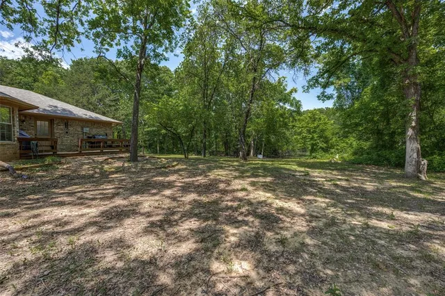 a backyard of a house with lots of green space