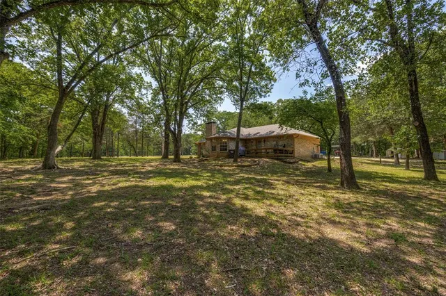 a backyard of a house with lots of green space