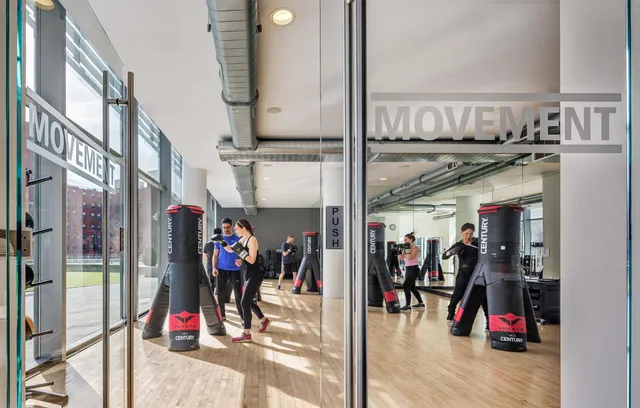 a living room with furniture and a painting on the wall