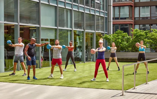 a group of people sitting in front of a building