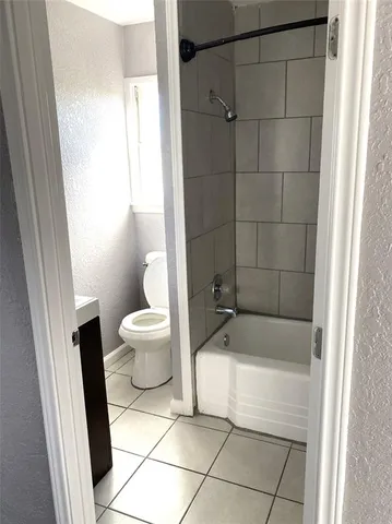 a bathroom with a bathtub and toilet