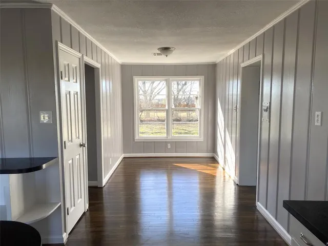 a view of entryway with wooden floor and door