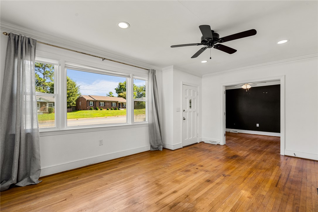 419 Whitehall Road Anderson, SC 29625 - Photo 5 of 28 Well-lit living area features hardwood floors and ample natural light through large windows.