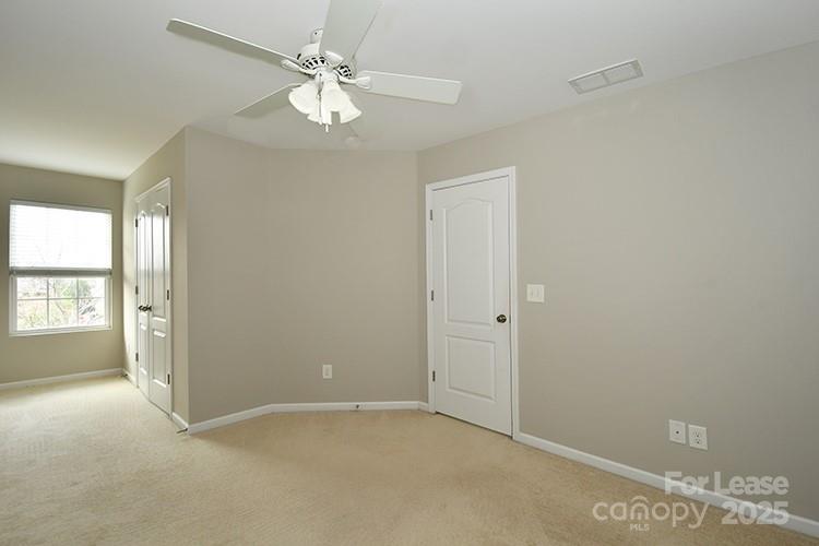 8204 Viewpoint Lane Cornelius, NC 28031 - Photo 11 of 27 an empty room with windows and ceiling fan