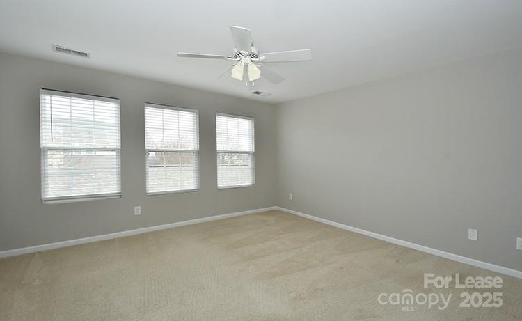 8204 Viewpoint Lane Cornelius, NC 28031 - Photo 14 of 27 an empty room with windows and fan