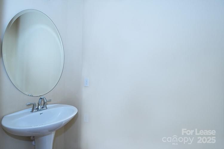 8204 Viewpoint Lane Cornelius, NC 28031 - Photo 16 of 27 a bathroom with a sink and a mirror