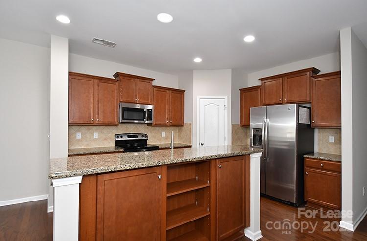 8204 Viewpoint Lane Cornelius, NC 28031 - Photo 5 of 27 a kitchen with stainless steel appliances granite countertop a refrigerator a stove a sink and a microwave