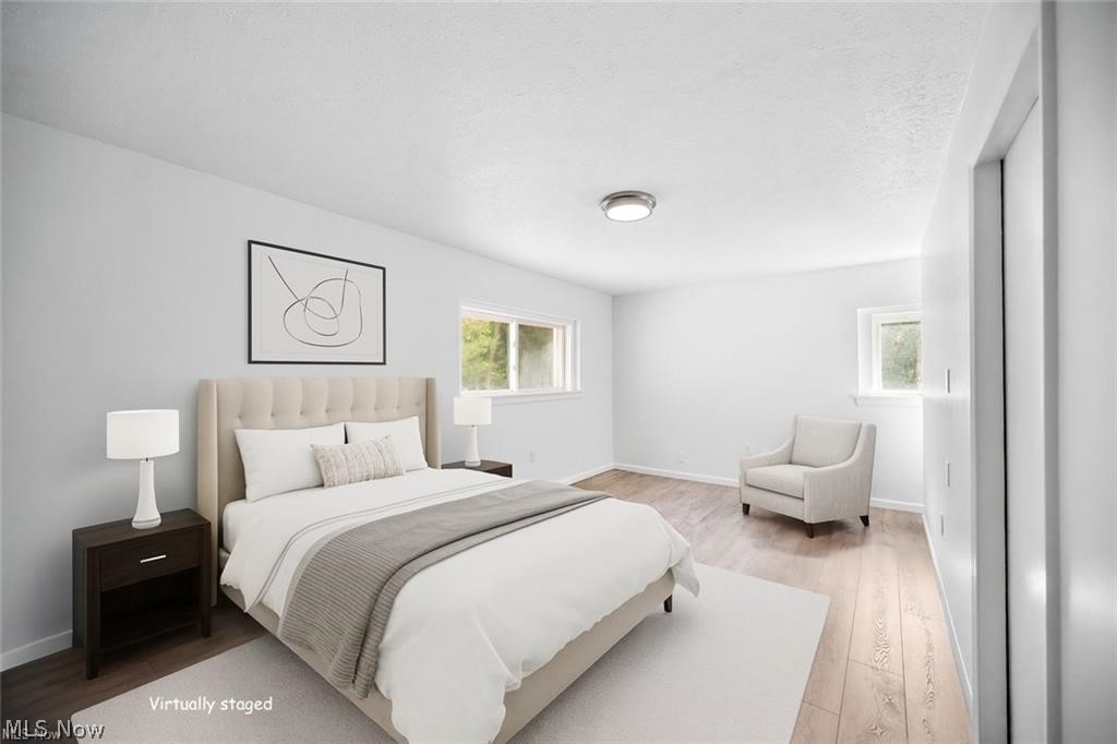 28300 Aurora Road Solon, OH 44139 - Photo 15 of 36 Bright room featuring wood-finish flooring, white walls, two windows, and a flush-mount ceiling light fixture