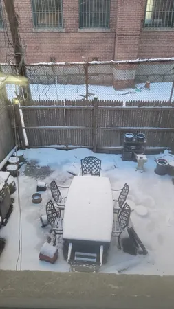 a view of a patio with table and chairs