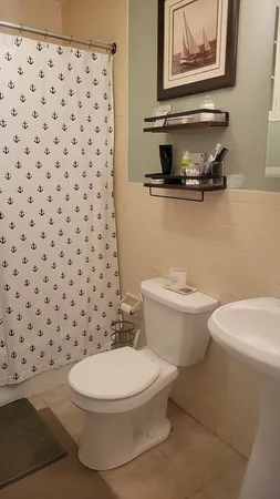 a white toilet sitting next to a bathroom sink