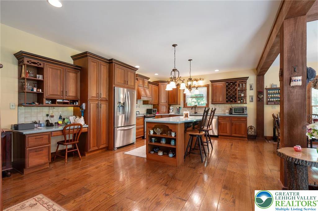 1222 Spring Road Andreas, PA 18211 - Photo 5 of 44 Rich wood cabinetry paired with
warm hardwood floors defines this
thoughtfully designed culinary