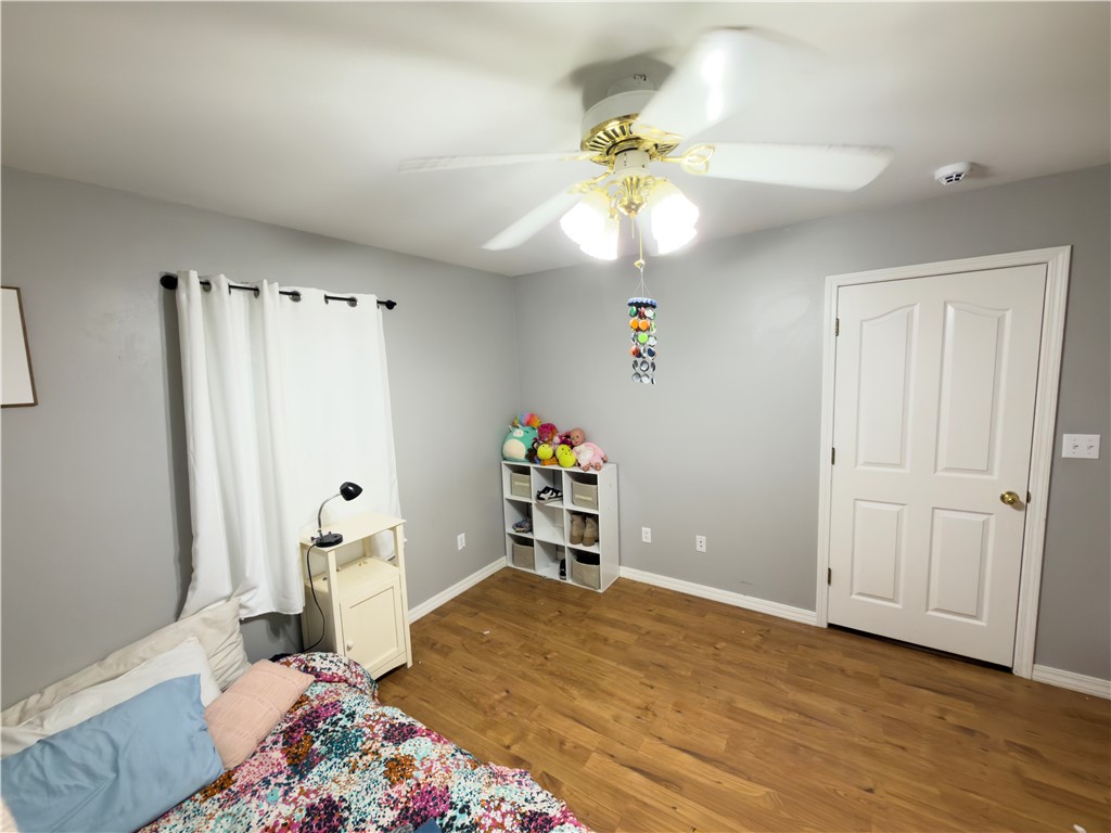 164 Park Road Russellville, AR 72802 - Photo 6 of 35 Room featuring wood-finish flooring, light grey walls, and a white interior door with a brass-finish doorknob