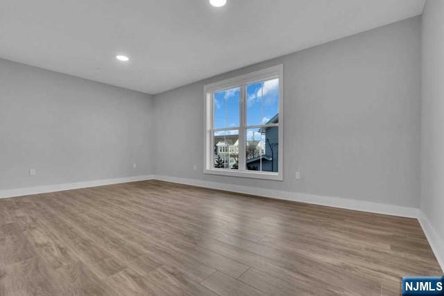 108 Ridge Road, Unit 302 North Arlington, NJ 07031 - Photo 14 of 15 a view of an empty room with wooden floor and a window