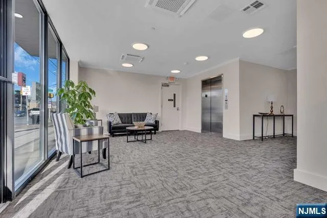 a view of a livingroom with furniture and a potted plant