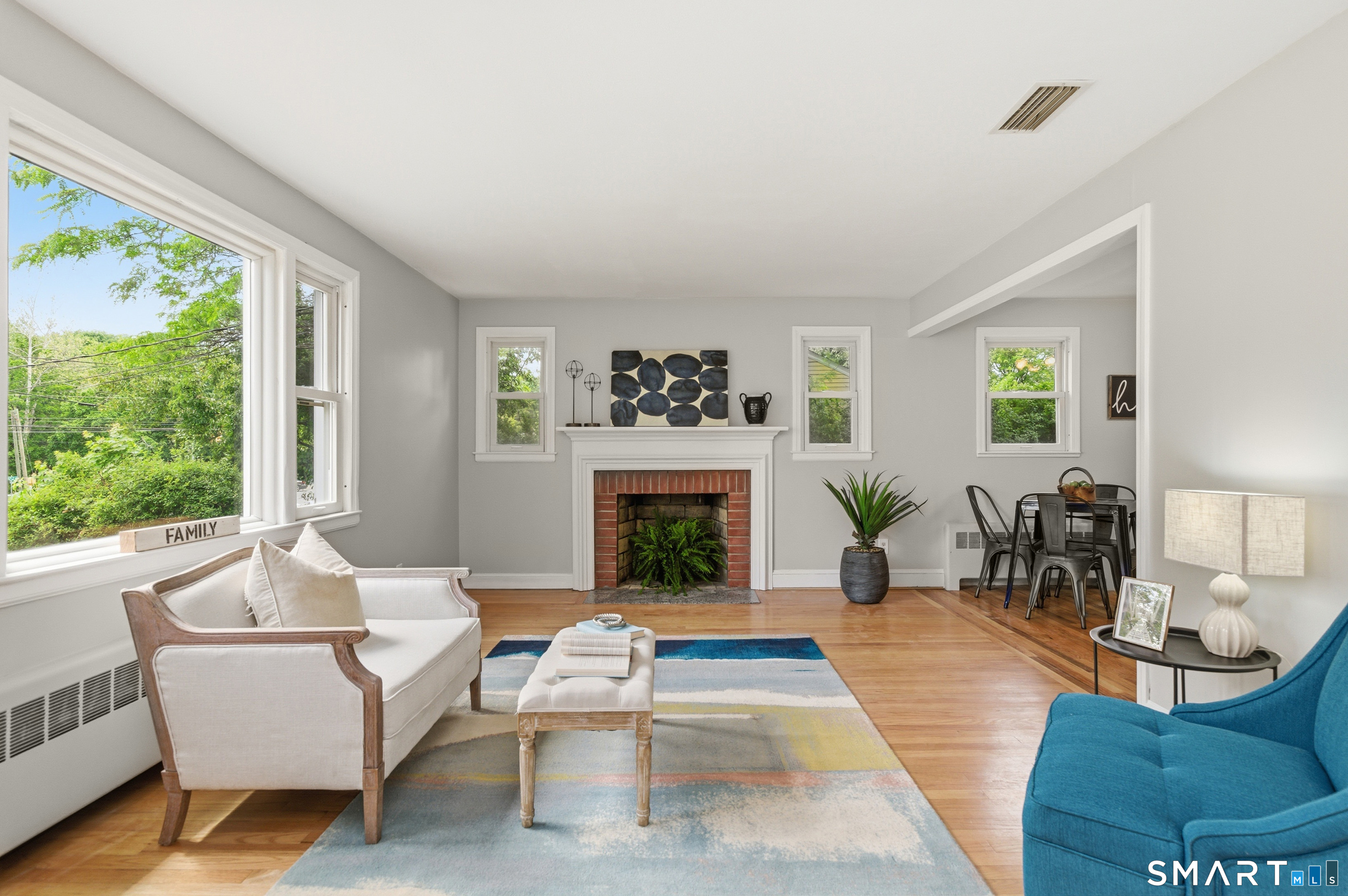 149 Mill Street Wethersfield, CT 06109 - Photo 2 of 29 a living room with furniture a fireplace and a large window