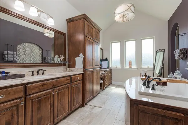 a bathroom with a sink double vanity granite and a mirror