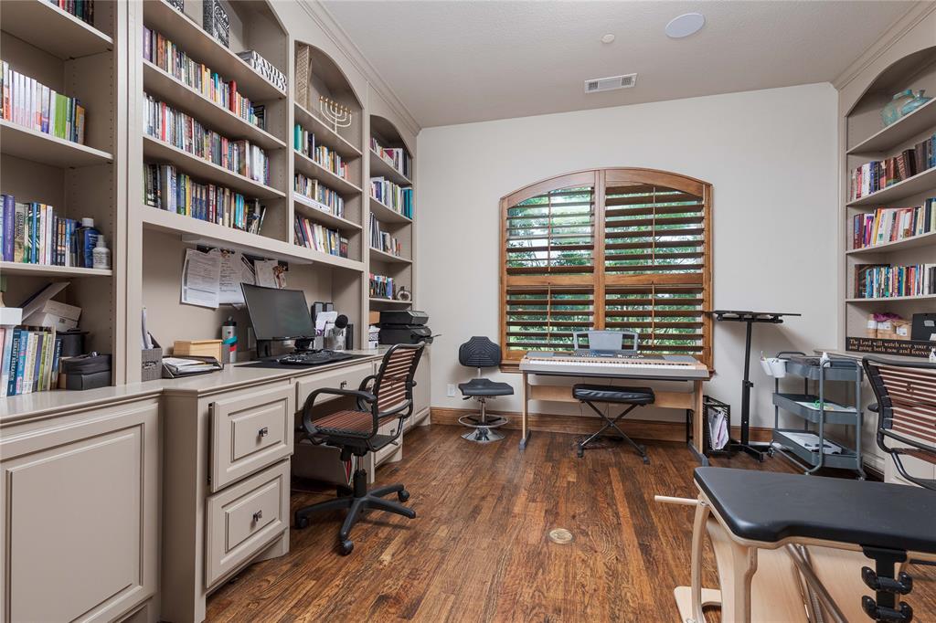 835 Bentwater Lucas, TX 75002 - Photo 17 of 40 a view of a workspace with furniture and a bookshelf