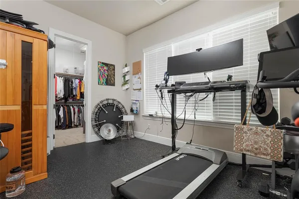 a room with gym equipment and a flat screen tv
