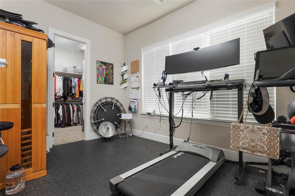 835 Bentwater Lucas, TX 75002 - Photo 20 of 40 a room with gym equipment and a flat screen tv