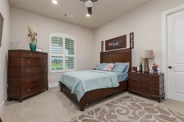 a bedroom with a bed and a night stand